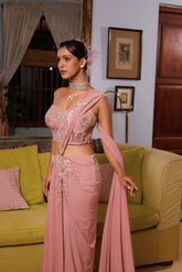 Exquisite pastel drape saree adorned with floral details, sparkling beads, and elegant bridal charm.