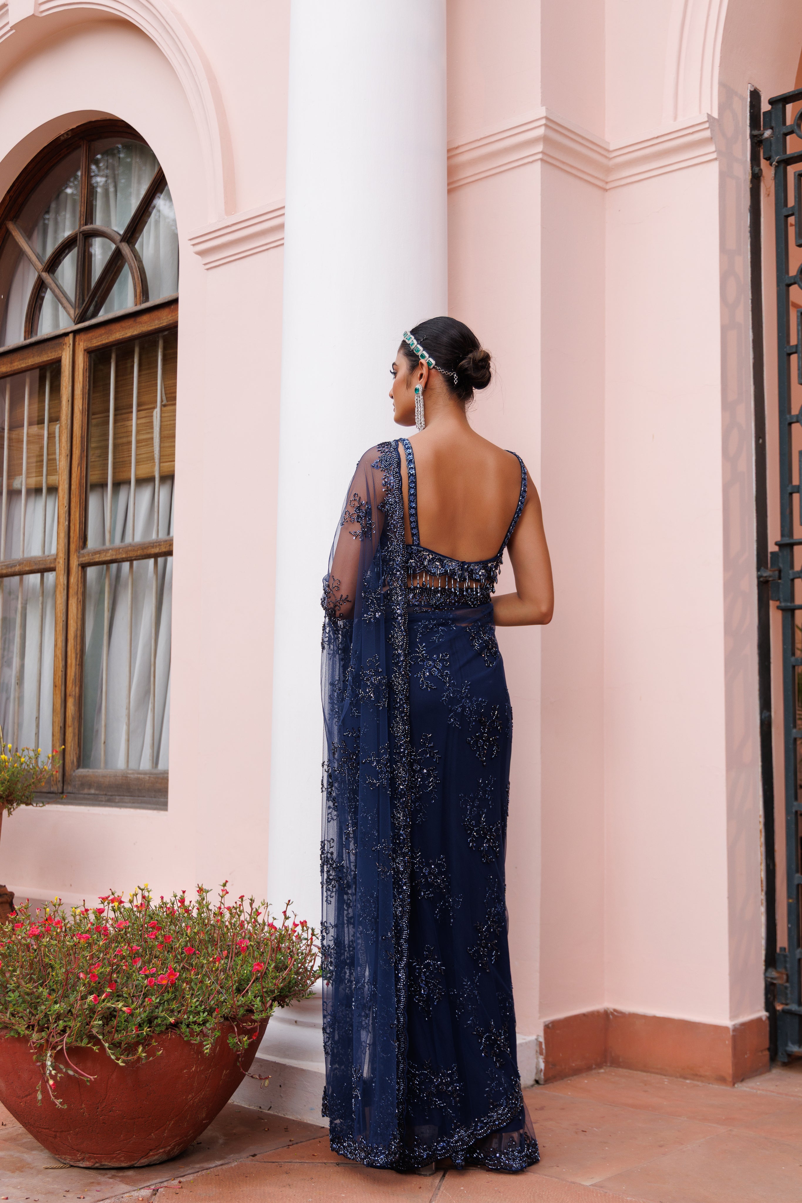 Exquisite Navy blue saree with sparkling floral details and intricate beadwork.
